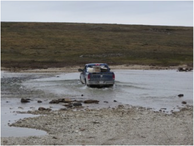 The truck crossing one of four rivers on the way to camp