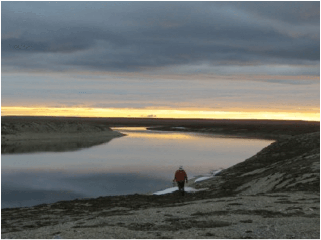 Mark collects water from the Sutton in an Arctic sunset.