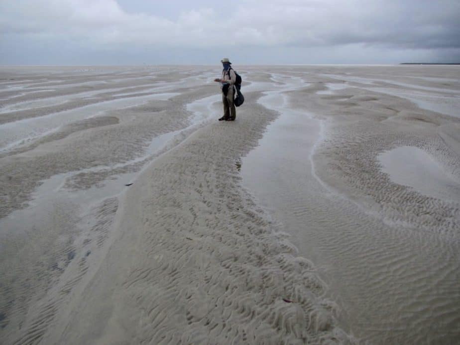 Mandy standing on the extensive sand flat of Core Criminosa Island