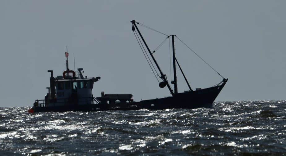 oyster boat braves shoal waters